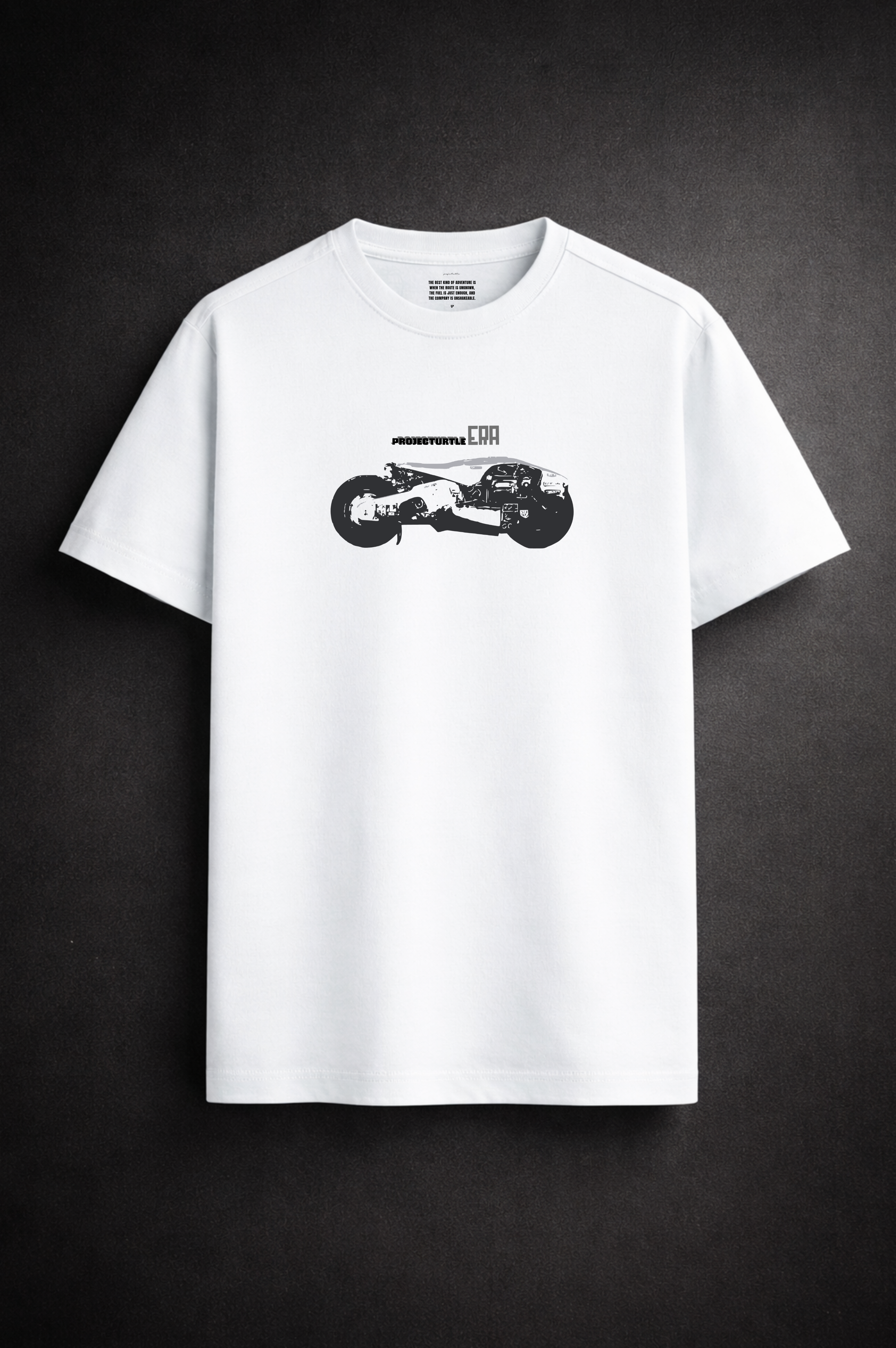 White t-shirt with a black graphic on a dark background